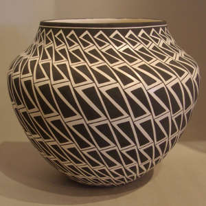 Interlocking geometric design on a black and white jar