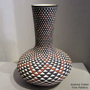 Step geometric design on a tall neck polychrome vase