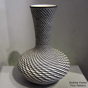 Step swirl geometric design on a tall neck black and white vase