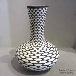 Step swirl geometric design on a tall neck polychrome vase