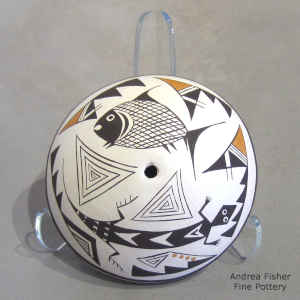 A Mimbres-style fish, lizard and geometric design on a polychrome seed pot