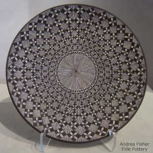 Fine line and geometric design on a black and white plate