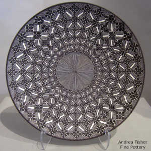 Fine line and geometric design on a black and white plate