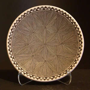 Fine line and geometric design on a black and white plate