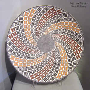 Polychrome platter with North Star fine line and spiral pumpkin seed and geometric design