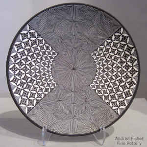 Black and white plate with North Star and snowflake fine line and pumpkin seed and geometric design