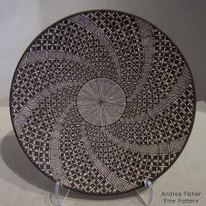 Fine line and swirl geometric design on a black and white plate