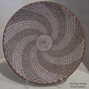 Fine line and swirl geometric design on a polychrome plate