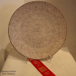 Fine line snowflake pattern design on a black and white plate