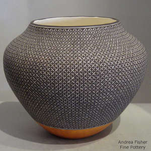 Fine line and geometric design on a polychrome jar