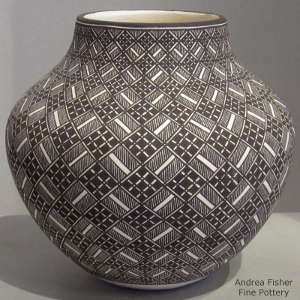 Fine line and geometric design on a black and white jar