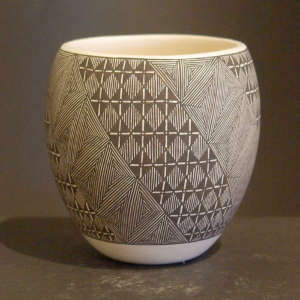 Fine line and geometric design on a black and white jar