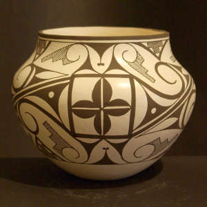 Floral and geometric designs on a black and white jar