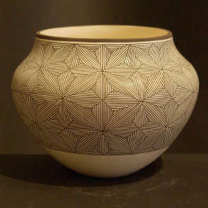 Fine line snowflake design on a black and white jar