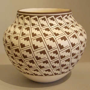 Interlocking kiva step design on a black and white storage jar