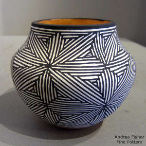 Black and white fine line snowflake design on a polychrome jar