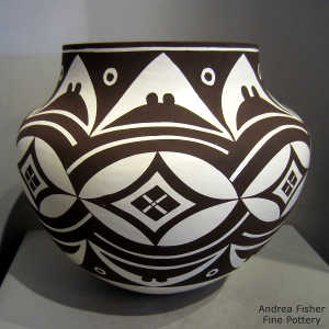 Eight panel geometric design on a black and white jar