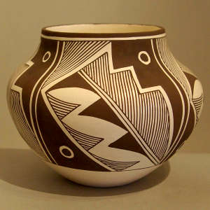 Fine line and geometric design on a black and white jar