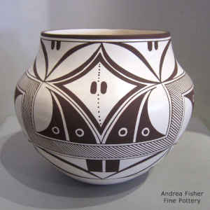 Fine line and geometric design on a black and white jar