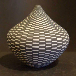 Black and white checkerboard design on a small jar