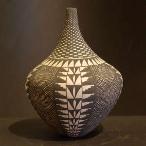 Fine line and geometric design on a tall neck black and white jar
