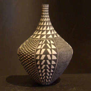 Fine line and geometric designs on a tall neck black and white jar