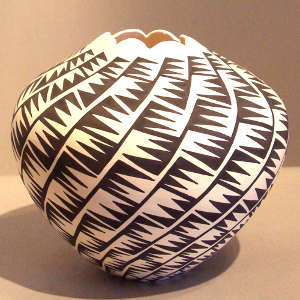Eagletail design and scalloped opening on a black and white jar
