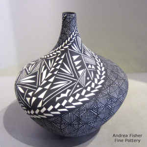 Fine line and geometric design on a black and white jar