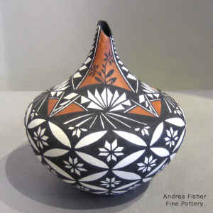 Pumpkin seed and geometric design on a polychrome tear drop jar