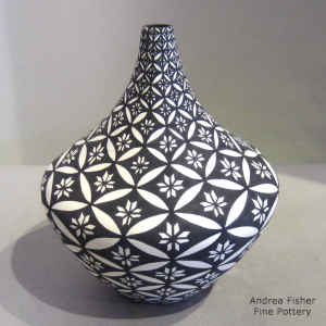 Pumpkin seed and geometric design on a black and white tear drop jar