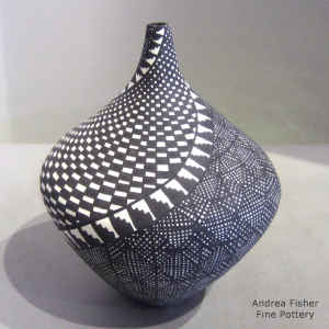 Spiral checkerboard, fine line and geometric design on a black and white tear drop jar