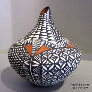 Pumpkin seed, checkerboard and geometric design on a polychrome tear drop jar