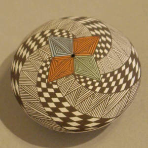 Four direction and swirl geometric design on a polychrome seed pot