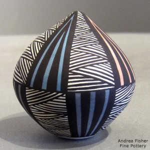Pointed top and geometric design on a polychrome seed pot