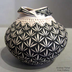 Geometric design and corrugated band on a black and white jar with custom opening