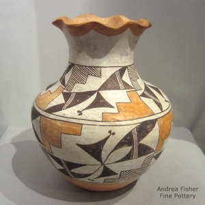 Pie crust rim and geometric design on a polychrome jar

