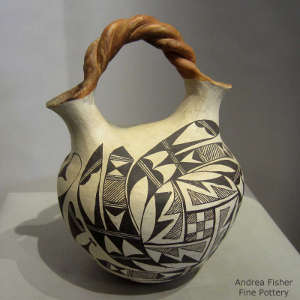 Black and white bird element and geometric design on a polychrome wedding vase with a twisted handle