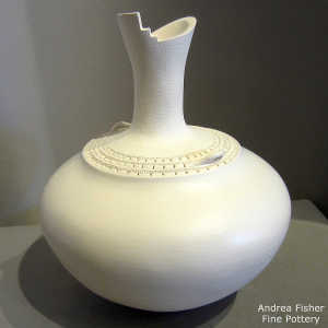 Band of corrugation around the neck of a tall neck white jar