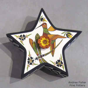 Hummingbird, dragonfly and flower design on the lidded top and black and white geometric design on the sides of a polychrome pentacle