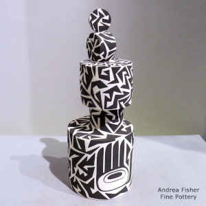 Geometric design on a lidded black and white sculptural piece