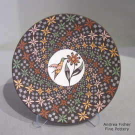 Hummingbird, flower and spiral geometric design on a polychrome plate
