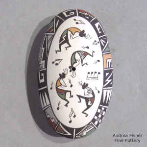 Flute player and geometric design on an oval miniature polychrome seed pot