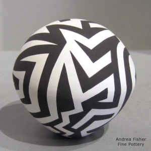 A tattoo geometric design on a black and white seed pot