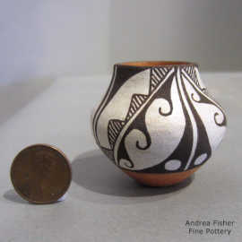 Black-on-white geometric design on a miniature polychrome jar