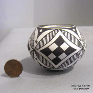 Fine line and geometric design on a miniature black-on-white jar
