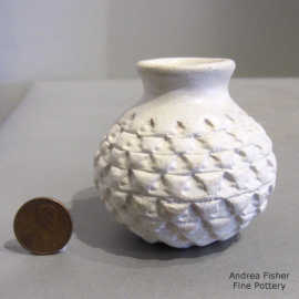 A corrugated surface on a miniature white jar