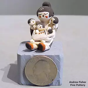 Four children on a miniature grandmother storyteller