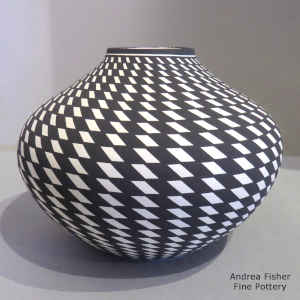 Spiral checkerboard geometric design on a black and white jar