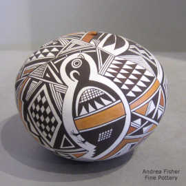 A Mimbres-style animal and geometric design on a polychrome seed pot