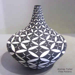 Snowflake geometric design on a tall neck black and white jar